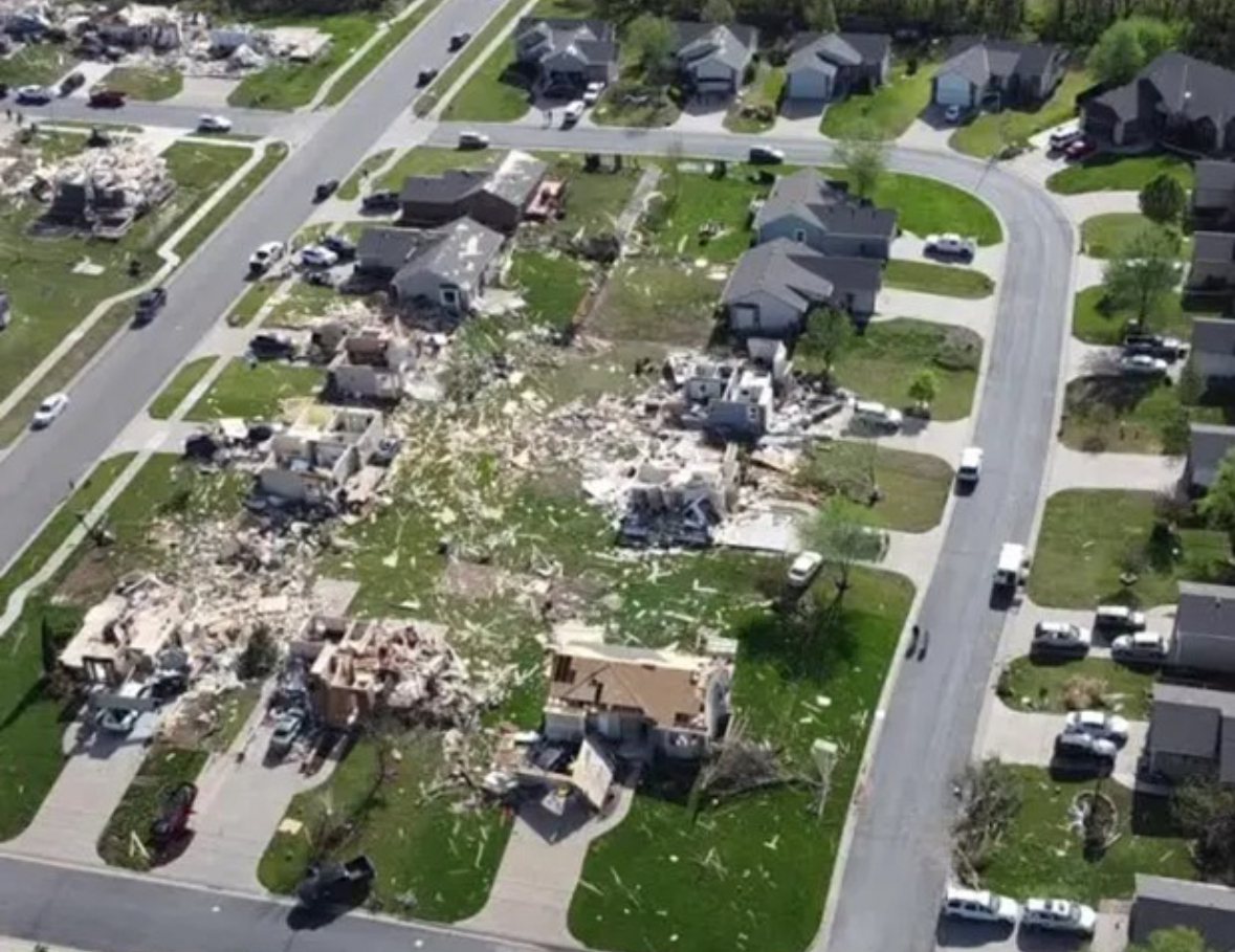 Aerial view of a residential subdivision with multiple homes destroyed by a tornado